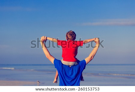 happy father and son playing on sea vacation