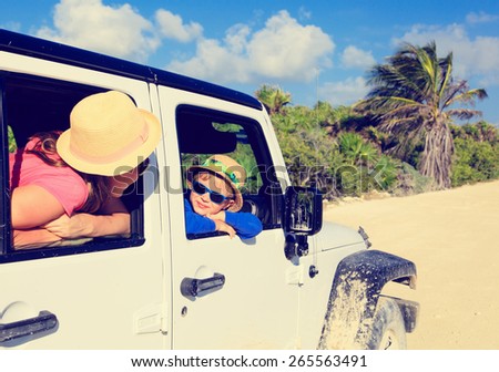 family driving off-road car on tropical beach, vacation concept