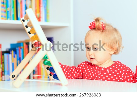 little girl playing with abacus, early learning