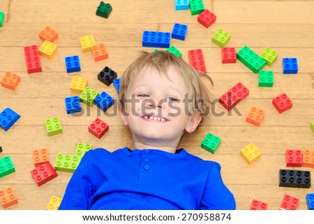child playing with colorful plastic blocks indoor, early learning