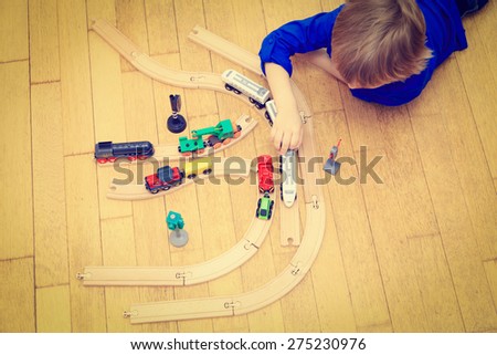 child playing with trains indoor, early learning