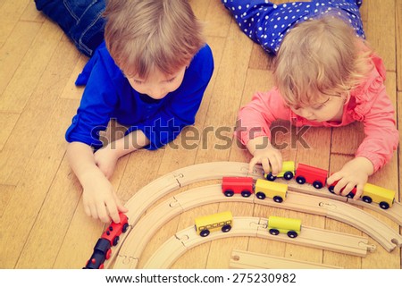 kids playing with railroad and trains indoor, learning and daycare