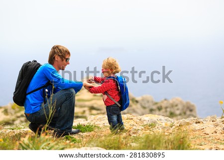 father and little daughter hiking in mountains, family travel
