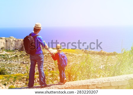 father and little son travel together in mountains