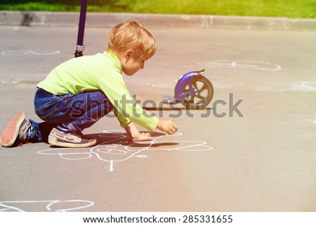 little boy drawing plane on asphalt, kids outdoor activities