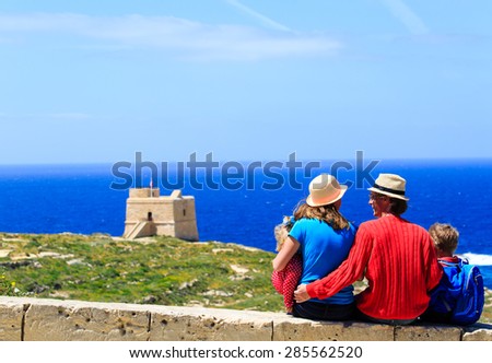 family with two kids looking at scenic view, family travel