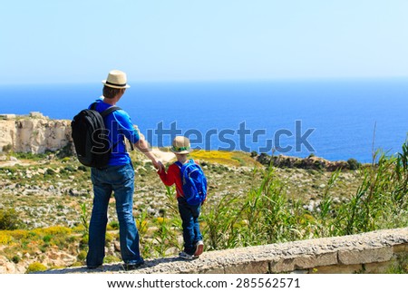 father and little son travel together in mountains