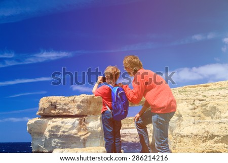 father and son making photo of Azure Window on Gozo island, family travel