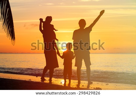 happy family with two kids having fun on sunset tropical beach