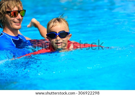Father teaching his little son to swim, kids sport