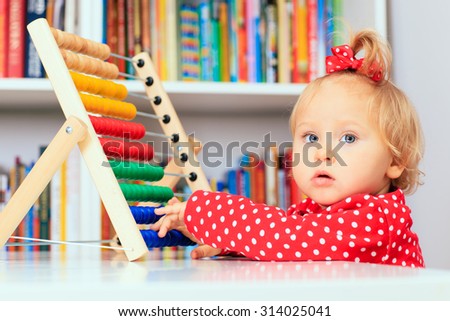 little girl playing with abacus, early learning concept