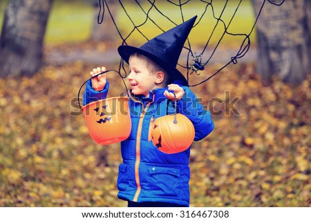 little boy in halloween costume in autumn park, kids trick or treating