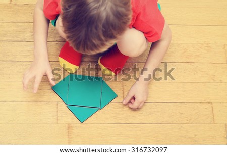 little boy playing with puzzle, early education concept