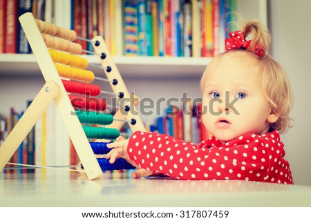 little girl playing with abacus, early learning concept