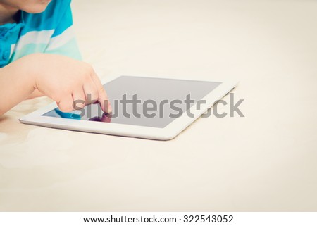child  finger with touch pad, early education and modern technology