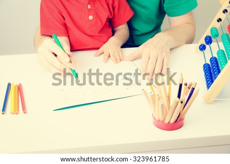 father and son playing with abacus, early education