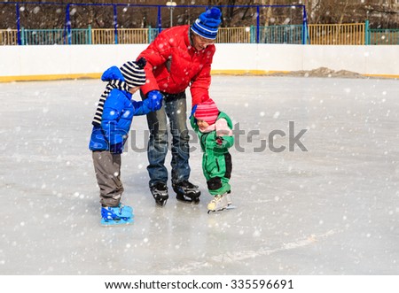 father with two kids skating in winter, family winter sport