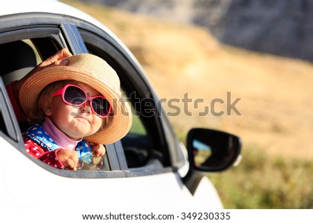 cute little girl travel by car in mountains, family vacation