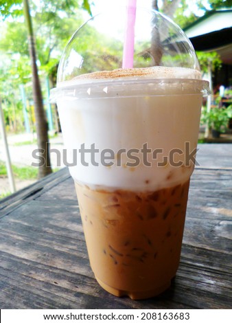 Iced coffee with milk or iced latte or iced cappuccino in takeaway plastic cup