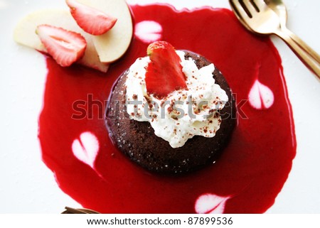 Molten Lava Chocolate Cake with strawberry sauce isolated on white