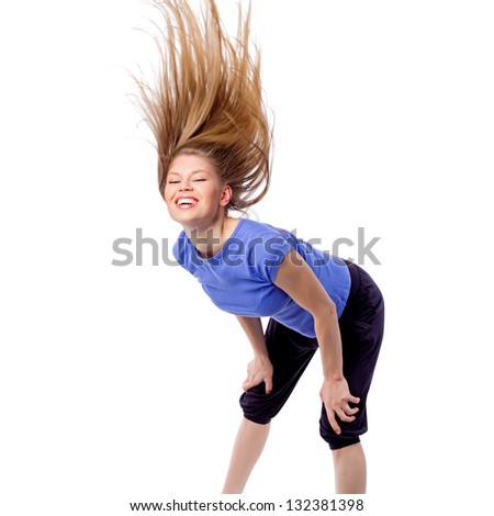 Pretty girl in dancing pose with disheveled hair. Female fitness/ aerobics trainer during dance class. Isolated on white background