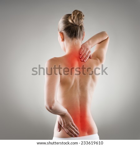 Lumbago and backbone stretch concept. Painful woman\'s back and neck indicated with red spot.