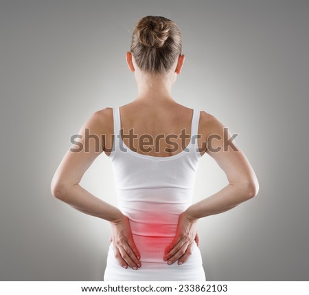 Loin spasm. Young woman with hurt backbone. Spine inflammation, pain and therapy.