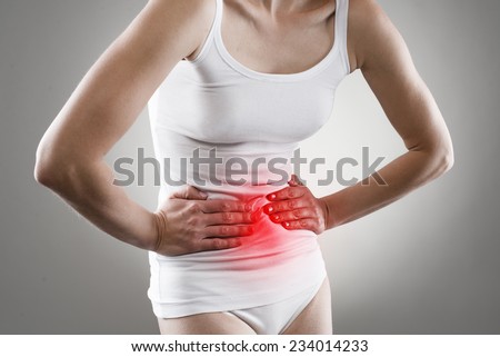 Young female having stomachache. Chronic gastritis. Ulcer. Abdomen bloating concept.