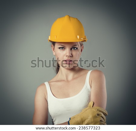Close-up portrait of female professional architect career beginner wearing helmet and gloves.