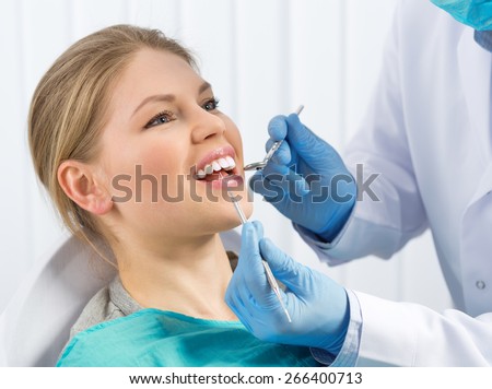 Pulp disease treatment. Root canal therapy. Young woman in dentist office curing painful tooth.