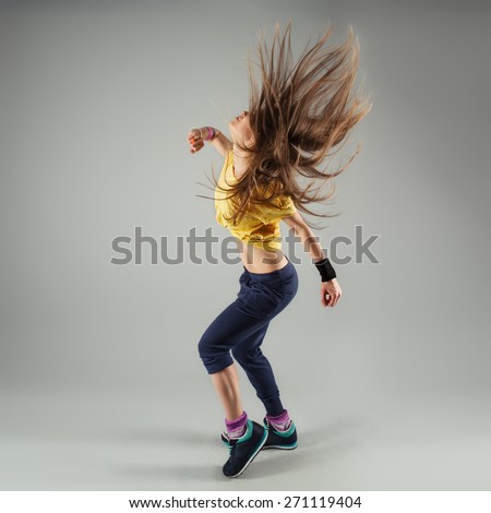 Young energetic woman jazz dancer moving in class. Beautiful slim female performer in motion.