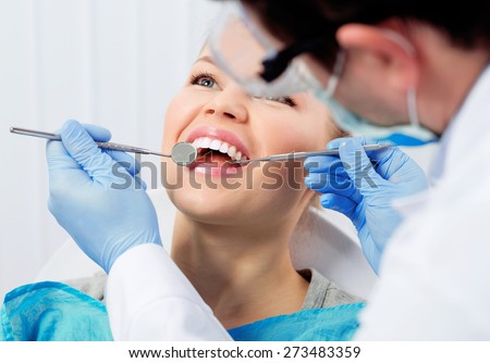Dental cure. Molar treatment. Young female patient visiting dentist office.