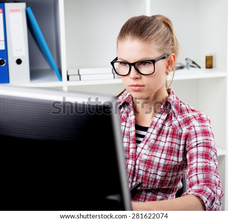 Concentrated woman journalist writing article for newspaper. Concept of work from home.