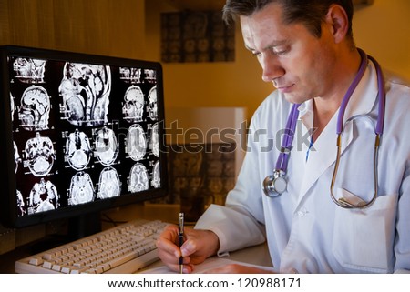 Doctor looking on ct scan at night duty