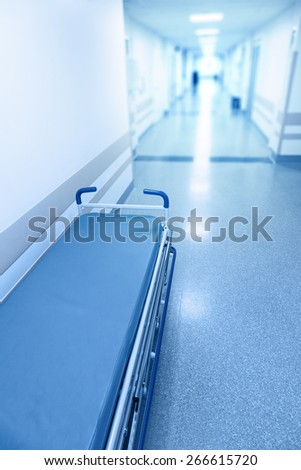 Long corridor in hospital with surgical gurney. Tinted picture