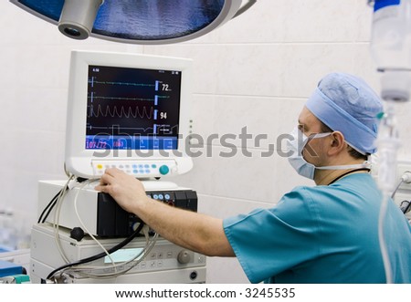 stock photo : anesthesiologist with equipment in operation room