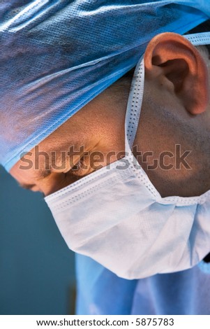 attentive look of working surgeon in operation room