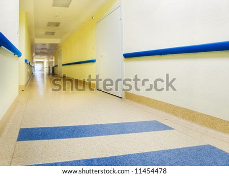 long yellow corridor in hospital with doors