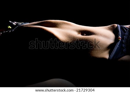 stock photo : young women with underwear and pierced navel on black 