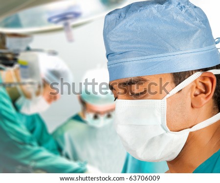 Male asian surgeon in operation room with his team