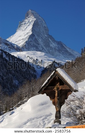 Cross with Jesus Christ in front of the famous Matterhorn mountain, Switzerland