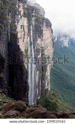 Trail down from the plateau Roraima passes under a waterfall - Venezuela, Latin America