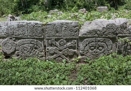 Images of the skull and bones on the rocks at the square of Palace of Death of the Uxmal - Yucatan, Mexico