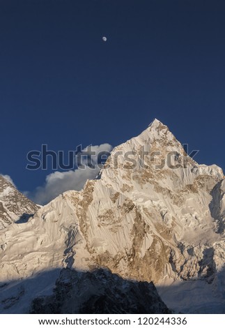 The Moon, Nuptse (7864 m), and slope of the Mt. Everest (8848 m) in the evening (view from Kala Patthar) - Nepal, Himalayas