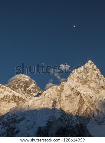 Moon over Mt. Everest (8848 m) and Nuptse (7864 m) at sunset (view from Kala Patthar) - Everest region, Nepal, Himalayas