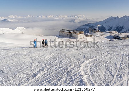 four skier on the background of ski chool - Kaprun, Austria
