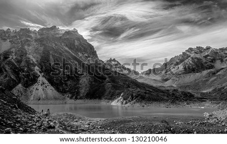A lone tourist near the fifth Gokyo lake ( Ngozumba Tsho ) - Nepal, Himalayas (black and white)