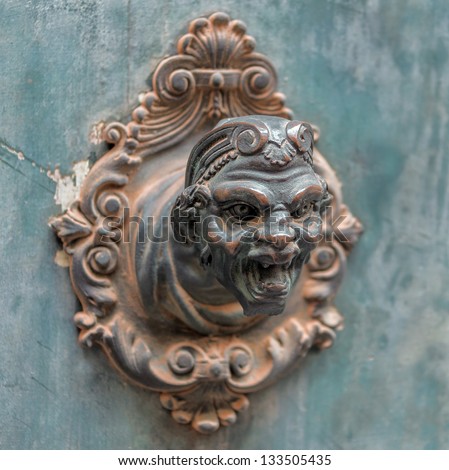 Beautiful brass sculpture serves as the door bell in the old house - Venice, Italy