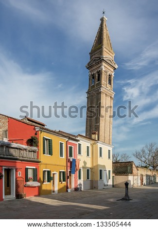 The colored houses near the old leaning Church Tower - Burano, Venice, Italy