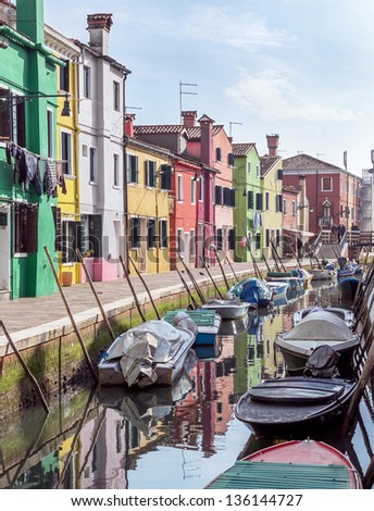 The colored houses on the shore of a narrow channel - Burano, Venice, Italy
